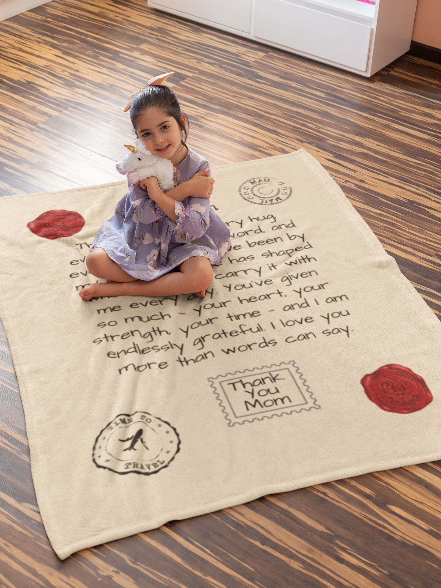 Standard Red Seal Letter to Mom Blanket without personalization shown with a child sitting on it.