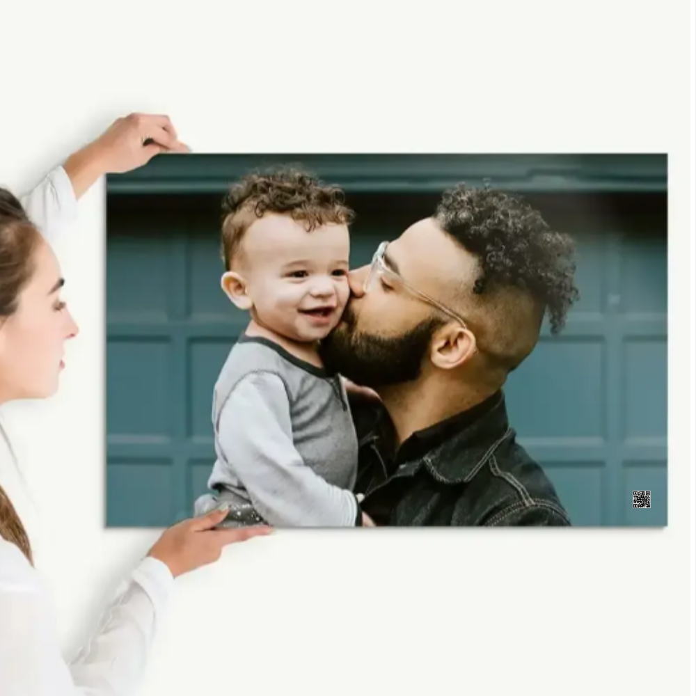 Man kissing a child on the cheek with a woman holding a foam audio message photo of them.  PhotoGiftPro